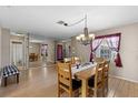 Bright dining room with wood floors and a chandelier at 6824 Jarvis Rd, Sarasota, FL 34241