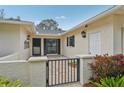 Courtyard entry with a gate and two exterior lights at 7157 Fairway Bend Cir, Sarasota, FL 34243