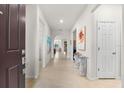 Bright and airy foyer with tile floors, artwork, and a glass-top console table at 7409 Chester Trl, Bradenton, FL 34202