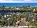 Aerial view of waterfront property showcasing expansive lot and canal access at 7536 Midnight Pass Rd, Sarasota, FL 34242