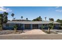 Recently renovated home featuring a double garage and palm trees at 765 Saint Judes N Dr, Longboat Key, FL 34228