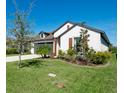 Two-story home with lush landscaping, showcasing curb appeal at 8219 Abalone Loop, Parrish, FL 34219