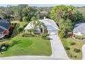 Bird's-eye view of a single-story house, lush landscaping, and a driveway at 8624 Woodbriar Dr, Sarasota, FL 34238