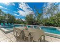 Enjoy alfresco dining adjacent to the refreshing pool at 115 Los Cedros Dr, Anna Maria, FL 34216