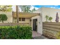 Condo's front entrance with covered walkway and mature shrubs at 123 Pinehurst Dr, Bradenton, FL 34210