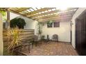 Relaxing patio area, shaded by a pergola, featuring brick pavers at 123 Pinehurst Dr, Bradenton, FL 34210