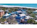 Aerial view of the charming beach house, featuring balconies and ample parking at 126/128 Avenida Veneccia, Sarasota, FL 34242