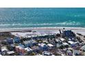 Aerial view of the charming beach house, near the sandy beach and turquoise ocean at 126/128 Avenida Veneccia, Sarasota, FL 34242