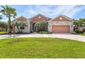 One-story house with stone accents, two-car garage and lush lawn at 13207 49Th E Ln, Parrish, FL 34219