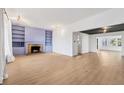 Light-filled living room with fireplace, built-in shelving, and hardwood floors at 1509 Flower Dr, Sarasota, FL 34239