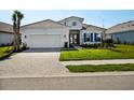 A beautiful home with a two-car garage and a brick-paved driveway at 15610 San Lazzaro Ave, Bradenton, FL 34211