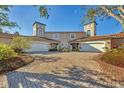 Two-story townhomes with white garage doors and brick driveway at 1719 Starling Dr # 1719, Sarasota, FL 34231