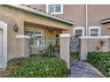 Front entry with wrought iron gate and brick walkway at 1719 Starling Dr # 1719, Sarasota, FL 34231