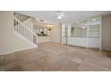 Open living area with tiled floors and a staircase leading upstairs at 1736 Burgos Dr, Sarasota, FL 34238