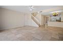 Open living area with tiled floors, kitchen view, and staircase at 1736 Burgos Dr, Sarasota, FL 34238