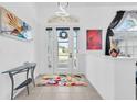 Bright entryway with glass front door and colorful rug at 23159 Allen Ave, Punta Gorda, FL 33980