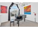Elegant music room featuring a grand piano and large windows at 23159 Allen Ave, Punta Gorda, FL 33980