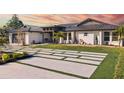 White modern home with metal roof and landscaped yard at 2350 Via Venice, Punta Gorda, FL 33950