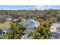 Beautifully landscaped home featuring a metal roof, well-manicured lawn, and a spacious driveway at 2500 Jamaica St, Sarasota, FL 34231