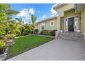 Charming home with a green lawn, stone accented landscaping, and a welcoming entrance at 2500 Jamaica St, Sarasota, FL 34231