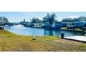 Community canal view with lush landscaping and water fountain at 3214 Pink Oak Ter, Sarasota, FL 34237