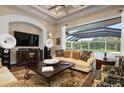 Living room with pool view and high-end entertainment system at 4022 Mayors Ct, Sarasota, FL 34240