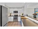 Modern kitchen with stainless steel appliances and white cabinets at 4500 Gulf Of Mexico Dr # 305, Longboat Key, FL 34228