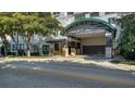 Elegant building entrance featuring a porte-cochère, lush landscaping, and the 'KANAYA' name displayed prominently at 505 S Orange Ave # 501, Sarasota, FL 34236
