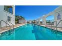 Relaxing swimming pool is surrounded by archways and a beautiful deck for sunbathing at 505 S Orange Ave # 501, Sarasota, FL 34236