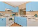 Bright kitchen with light blue cabinets and modern appliances at 535 Spring Lakes Blvd, Bradenton, FL 34210