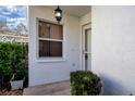 Inviting front entrance with a tiled patio and well-manicured shrubs at 5807 Garden Lakes Fern # 5807, Bradenton, FL 34203