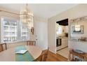 Dining area featuring a chandelier, adjacent kitchen view, and hardwood floors at 5903 Canal Dr # I24, Bradenton, FL 34207
