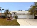 Front view of a single story home with tile roof and two car garage at 7212 Southgate Ct, Sarasota, FL 34243