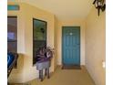 Condo entryway with teal door and potted plant, welcoming and charming at 7315 River Hammock Dr # 206, Bradenton, FL 34212