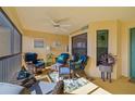 Relaxing screened porch with wicker furniture, creating a cozy outdoor space at 7315 River Hammock Dr # 206, Bradenton, FL 34212