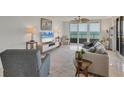 Spacious living room with ocean views, contemporary furniture, and stylish accents at 775 Longboat Club Rd # 902, Longboat Key, FL 34228