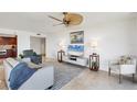 Inviting living room features a modern design, plush seating, and a large TV for entertainment at 775 Longboat Club Rd # 902, Longboat Key, FL 34228