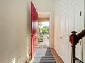 Bright entryway with red door opening to a courtyard at 8267 Nandina Dr, Sarasota, FL 34240