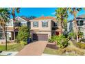 Two-story house with brown roof, red door, and brick driveway at 8267 Nandina Dr, Sarasota, FL 34240