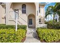 Condo entrance with stairs and well-manicured landscaping at 8335 Glenrose Way # 1513, Sarasota, FL 34238