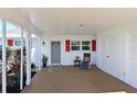 Covered patio with seating area, adjacent to garage at 9413 Andover Cir, Bradenton, FL 34210