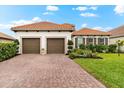 Beautiful home featuring a red tile roof, a two-car garage, and a brick paver driveway at 10120 Carnoustie Pl, Bradenton, FL 34211