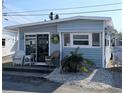Quaint beachfront cottage with a welcoming front porch and landscaping at 10315 Cortez W Rd # 58-3, Bradenton, FL 34210
