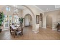 Bright and spacious entryway with high ceilings, arched doorways and tile floors leading to other rooms at 110 Asti Ct, North Venice, FL 34275