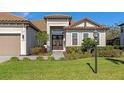 Front view of a house with a double door entry and mature landscaping at 16219 Tradewind Ter, Bradenton, FL 34211