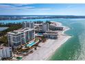 Aerial view of a beachfront condo complex with pool and beach access at 1800 Benjamin Franklin Dr # B408, Sarasota, FL 34236