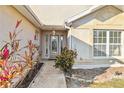 Front entry with a glass door and landscaping at 21264 Wynyard Ave, Port Charlotte, FL 33954