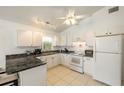 Bright kitchen with white cabinets and granite countertops at 2711 Larkspur Dr, Punta Gorda, FL 33950