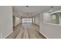 Spacious living room featuring light wood-look floors and a view of the pool at 2914 112Th E Ter, Parrish, FL 34219