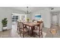 Virtually staged dining room, featuring a large table and chandelier at 3107 34Th Avenue W Dr, Bradenton, FL 34205